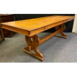 An early 20th century pine trestle dining table, 216cm long x 78cm wide x 77cm tall.