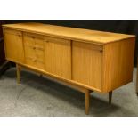 A mid 20th century Danish style teak side cabinet credenza, with three sliding and hinged doors,