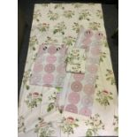 A pair of large floral lined curtains, pale pink roses on a cream ground, 228cm drop, 264cm wide;