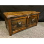 An 18th century blanket chest (with later modifications), pollard oak lid, carved lion mask