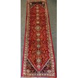 A fine Persian Abadeh runner rug / carpet, the central field densely woven in tones of deep red,