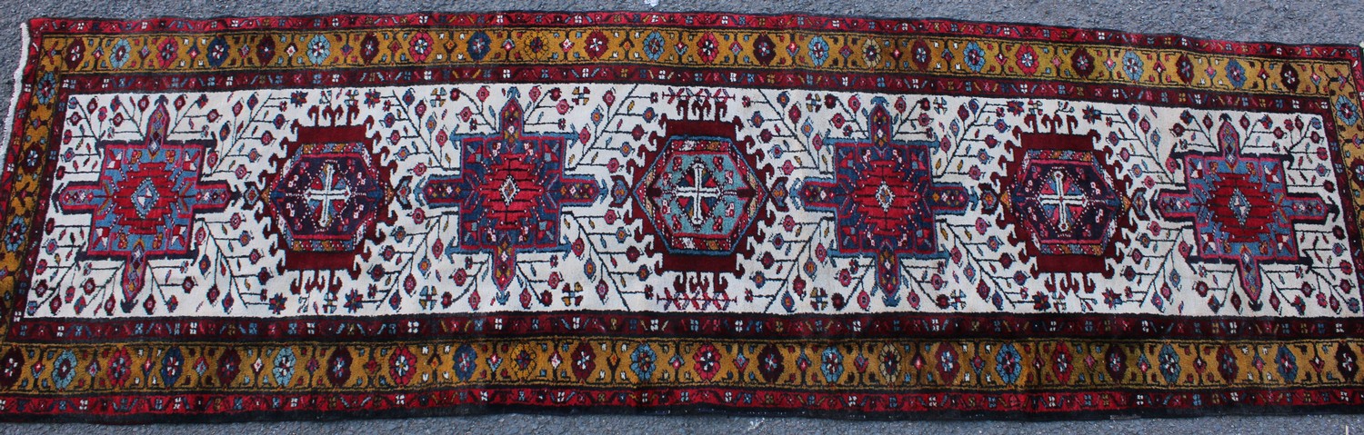 A Persian hand-made Heriz runner, 332cm x 96cm