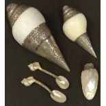 An Indian metal mounted conch shell, probably low grade silver, 21cm long; another smaller15cm; a