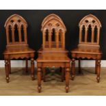 A set of four Victorian style oak Gothic design hall chairs, 93cm high, 46cm wide, the seat 35cm