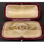 A late 19th/early 20th century 9ct gold bar brooch, set with seed pearls and central ruby, guard