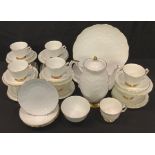 Aynsley Golden Crocus tea ware, including 10 cups and saucers, coffee pot, three tea plates, etc.,