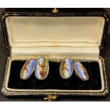 A pair of silver and enamel cufflinks, each decorated in polychrome with a horse and jockey, boxed