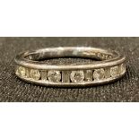 An 18ct white gold half eternity ring, with channel set diamonds, size K, 3g, boxed