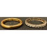 A 22ct gold wedding band, size P, 8.2g; a 9ct gold eternity ring, size P, some stones lacking, 2.