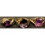 A 9ct gold ring, set with a central oval cut amethyst, size N/O; two other 9ct gold and amethyst