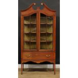 A Sheraton Revival satinwood crossbanded mahogany display cabinet, swan neck pediment inlaid with