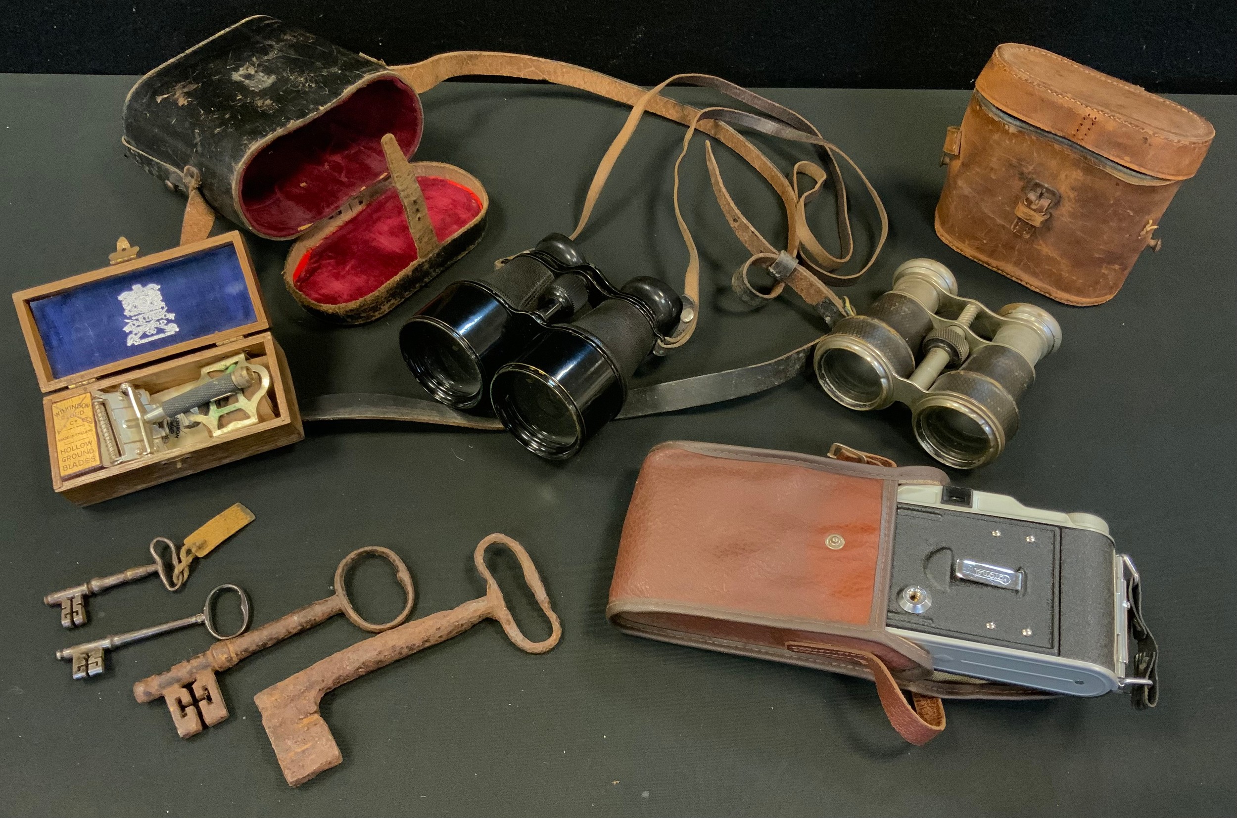 A pair of early 20th century binoculars; others folding cameras; etc
