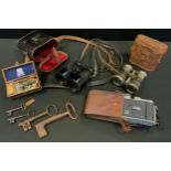 A pair of early 20th century binoculars; others folding cameras; etc