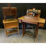A Singer manual wind portable sewing machine, oak case; another treadle table mounted; two sewing