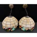 A pair of stained and leaded marbleized glass light fittings, dodecagonal body with Fruit collar