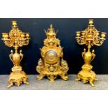 A large reproduction gilt metal clock garniture, the side candelabra with six lights