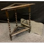 An oak triangular stick stand, barley twist legs, c.1930; a bevelled mirror (2)