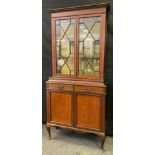 An early 20th century mahogany display cabinet, moulded cornice, above two astragal glazed doors,