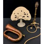 An Art Nouveau brass table lamp; cast iron tree of life book stand; a copper bugle (3)