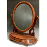 A Victorian mahogany dressing table mirror, serpentine scrolling supports, oval plate above flat