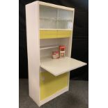 A 1960's Remploy floor standing kitchen cupboard, sliding glass doors to top enclosing shelving,