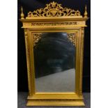 A gilt overmantel mirror, pierced and carved cresting, the pane flanked by turned columns, 85cm