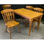 A set of four pine kitchen chairs, H stretchers; a rectangular kitchen table, 73cm high, 64cm wide