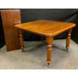 A Victorian mahogany wind-out dining table, rounded rectangular top, tapering reeded legs, brass