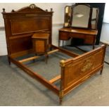 A French Empire style mahogany and Kingwood inlay bedroom suite, comprising gilt metal-mounted