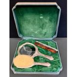 A continental silver three piece dressing table set, hand mirror, comb and brush, stamped