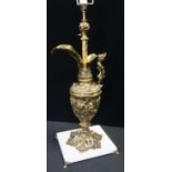 A large brass Neoclassical table lamp, as a Ewer cast with figures, putti masks scrolls, marble