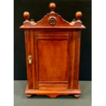 An Edwardian mahogany smokers cabinet, shaped ball pediment, single panel door, fitted interior,