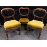 A pair of Victorian Balloon-back mahogany side chairs, c.1890; another similar chair, (3).