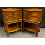 A pair of reproduction mahogany bedside cabinets, each with three quarter galleried top,