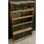 A Minty, 'Library Specialists', five tier stackable oak bookcase, sliding glazed doors, 161.5cm tall