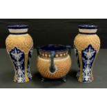 A pair of Doulton Lambeth ovoid vases, applied with panels of stylised flowers, the ground incised
