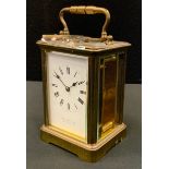 An early 20th century brass carriage clock, Roman numerals, inscribed Howell James and Co, London