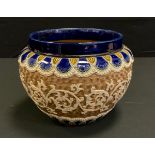 A Doulton Lambeth jardiniere, applied with leafy scrolls, the ground with spirals, 23cm diam,