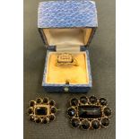 A 19th century jet mourning brooch, the yellow metal mount, engraved Maria Smith 1833; another