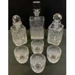 A pair of 20th century clear glass canted square decanters; another, rectangular, with four tumblers