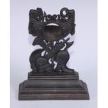 A 19th century cast iron pocket watch stand, cast with triumphal regalia, stepped rectangular