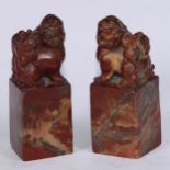 A pair of Chinese soapstone desk seals, each carved with a temple lion, 13.5cm high