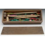 An early 20th century table croquet set, the pine box with sliding cover, 50cm wide