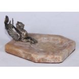 An alabaster desk tidy, mounted with a silvered wyvern, 15.5cm wide