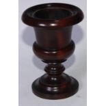 Treen - a 19th century lignum vitae campagna urn, outswept everted rim, turned pedestal base, 21.5cm