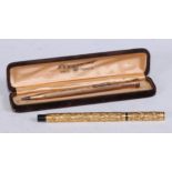Pens - an early 20th century gold coloured metal mounted fountain pen, by Aikin Lambert & Co,