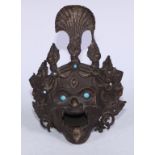 A Tibetan bronze demon-head censor, set with turquoise jewels and eyes, 19cm high