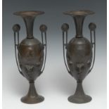 A pair of 19th century Grecian Revival brown patinated bronze vases, each cast with portrait ovals