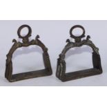 A pair of Mughal Indian bronze stirrups, cast in the Islamic taste with birds and chased with