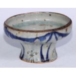 A Middle Eastern circular bowl, thickly glazed and sparsely decorated in the Persian manner with